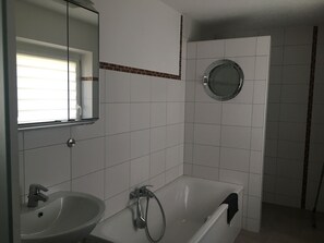 Bathtub, hair dryer, towels, soap