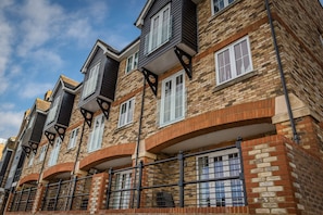 A multi-story residential building with brick facade, multiple windows, and balconies. - Silver Strand - stunning marina views, stylish design, parking & 3 bathrooms! (Eastbourne)