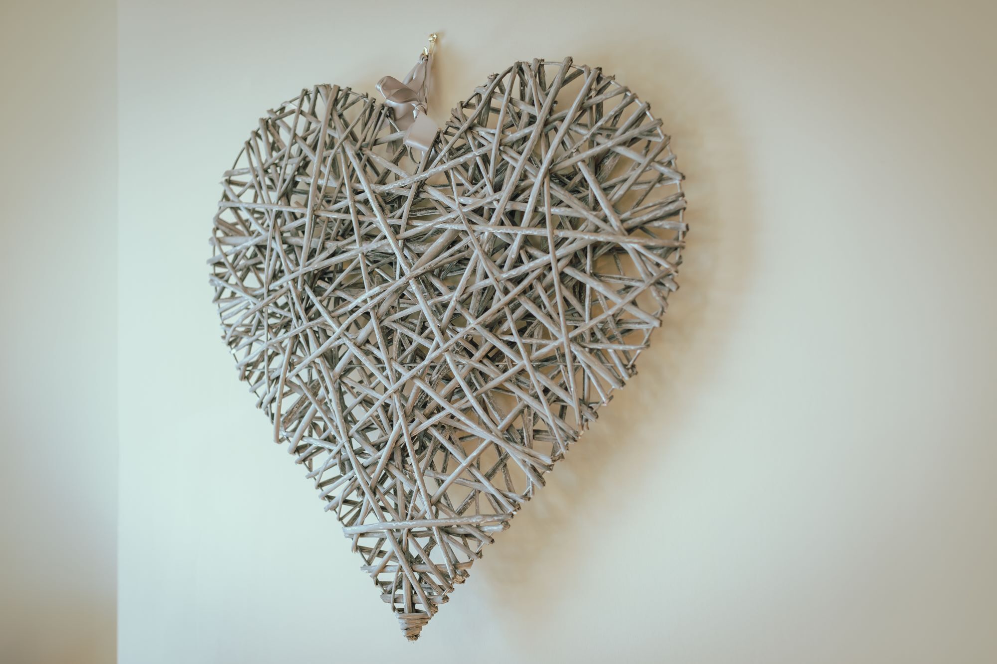 A heart-shaped wall decoration made of intertwined branches.