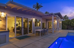 A modern house with a pool, sliding glass doors, and outdoor seating. - Movie Colony Contemporary (Palm Springs)