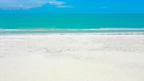 A beach with clear turquoise water and white sand. - Sanibel Surfside 115: Gorgeous Gulf Front Oasis! (Sanibel)