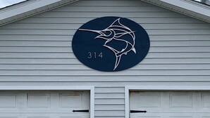 A building with a garage door and a circular sign with the number 314.