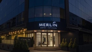 A modern hotel building with a curved facade and illuminated signage reading "MERLIN HOTEL ISTANBUL". - Merlin Hotel Istanbul (Istanbul)