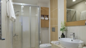 A modern bathroom with a glass-enclosed shower, a white sink, and a toilet. - Merlin Hotel Istanbul (Istanbul)