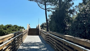 A wooden boardwalk leading to a viewpoint, surrounded by trees and clear skies. - E-SEA-LIVIN' Oceanside Coastal Cottage in Corolla, 4 min walk to the beach! (Corolla)