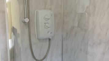 Combined shower/bathtub, hair dryer, towels, toilet paper