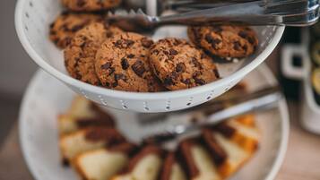 Un colador blanco lleno de galletas con chispas de chocolate.