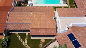 A residential area with a swimming pool, tiled roofs, and a well-maintained lawn. - La Corte di Pulicinu (Arzachena)