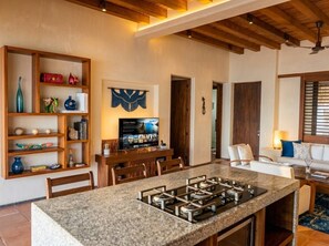 A modern kitchen with a granite countertop and built-in gas stove.