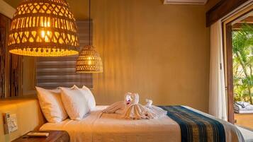 A hotel room with a bed, two hanging lamps, a window with a view, and an air conditioning unit.