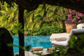 A poolside area with a lounge chair, a towel, and a fruit bowl. - Casamar, beach front estate on Troncones Point (La Majahua)