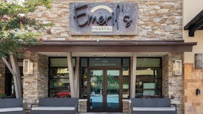 Welcome to Emeril's Coastal, where a stone facade and glass door greet you at the entrance on Grand Boulevard.