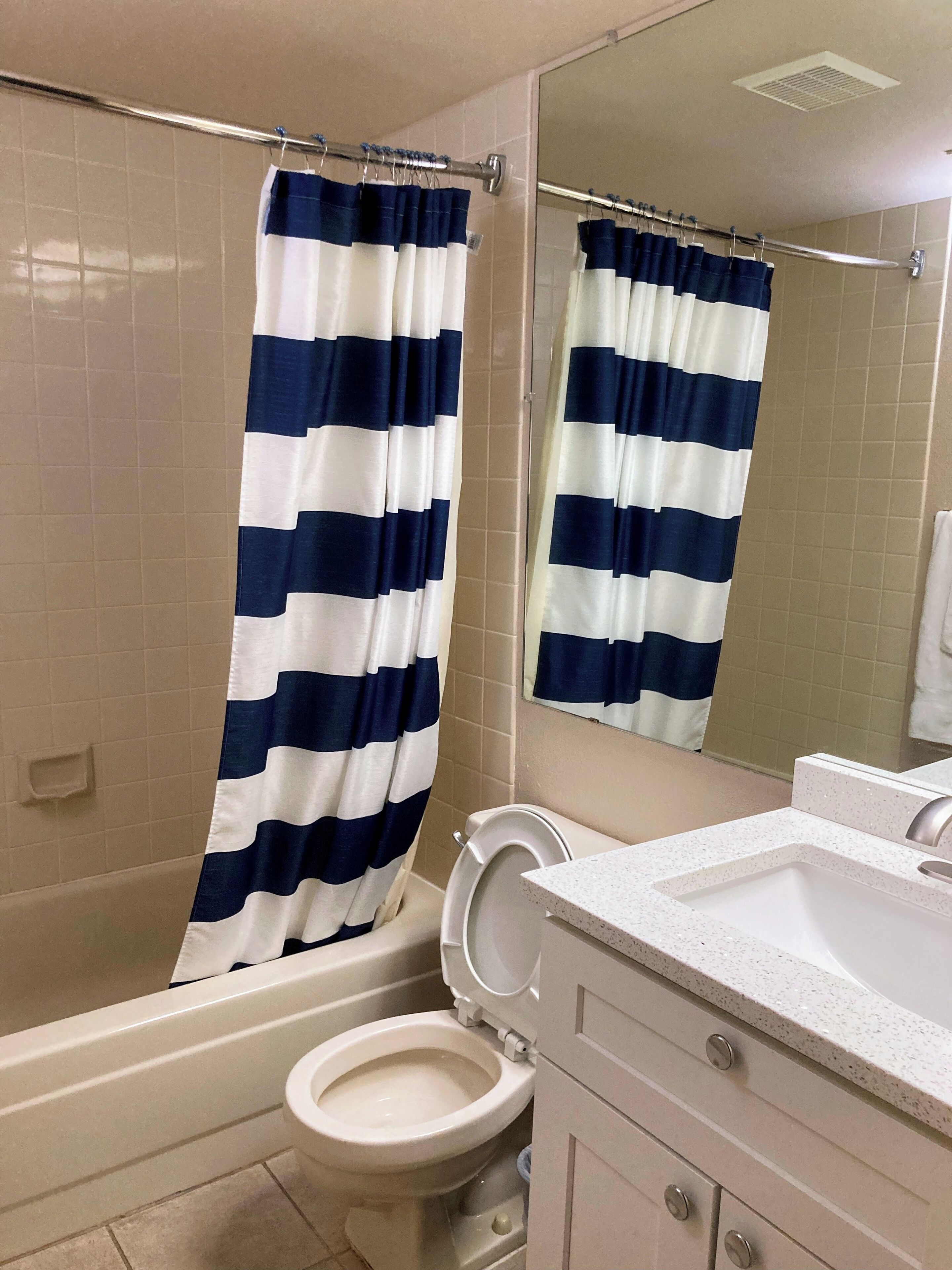 A bathroom with a bathtub, a toilet, and a sink.