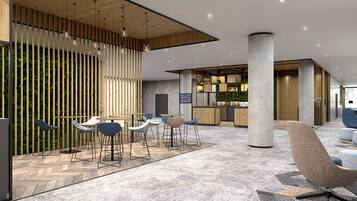 A modern interior with a seating area, a bar, and a reception desk.