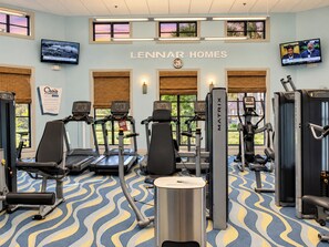 A gym with treadmills, weight machines, and exercise mats.
