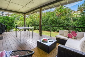 An outdoor patio with a table, chairs, and a sofa. - Surf Hale, Elegant and Luxurious Surf Retreat (Princeville)