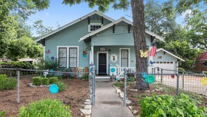 A light blue house with a number 504 sign, a front porch, and a small garage. - .6 miles to Marktplatz - Walkable to Downtown - Firepit - (Fredericksburg)