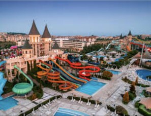 A water park with multiple slides and pools, surrounded by buildings. - 1-bed Modern Sea View Apartment in Aparthotel (Pomorie)
