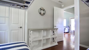 A bedroom with two beds, a white dresser, and a wall-mounted life preserver. - JOMO TriTerrace Enjoy Family, Relax Lakefront, Lake View, Priv dock Boat Slip (Rocky Mount)