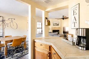 A modern kitchen with a dining area, a living room, and a fireplace. - 2-Bedroom Condo in the Foothills, La Encantada, Galleries and Restaurants! (Tucson)