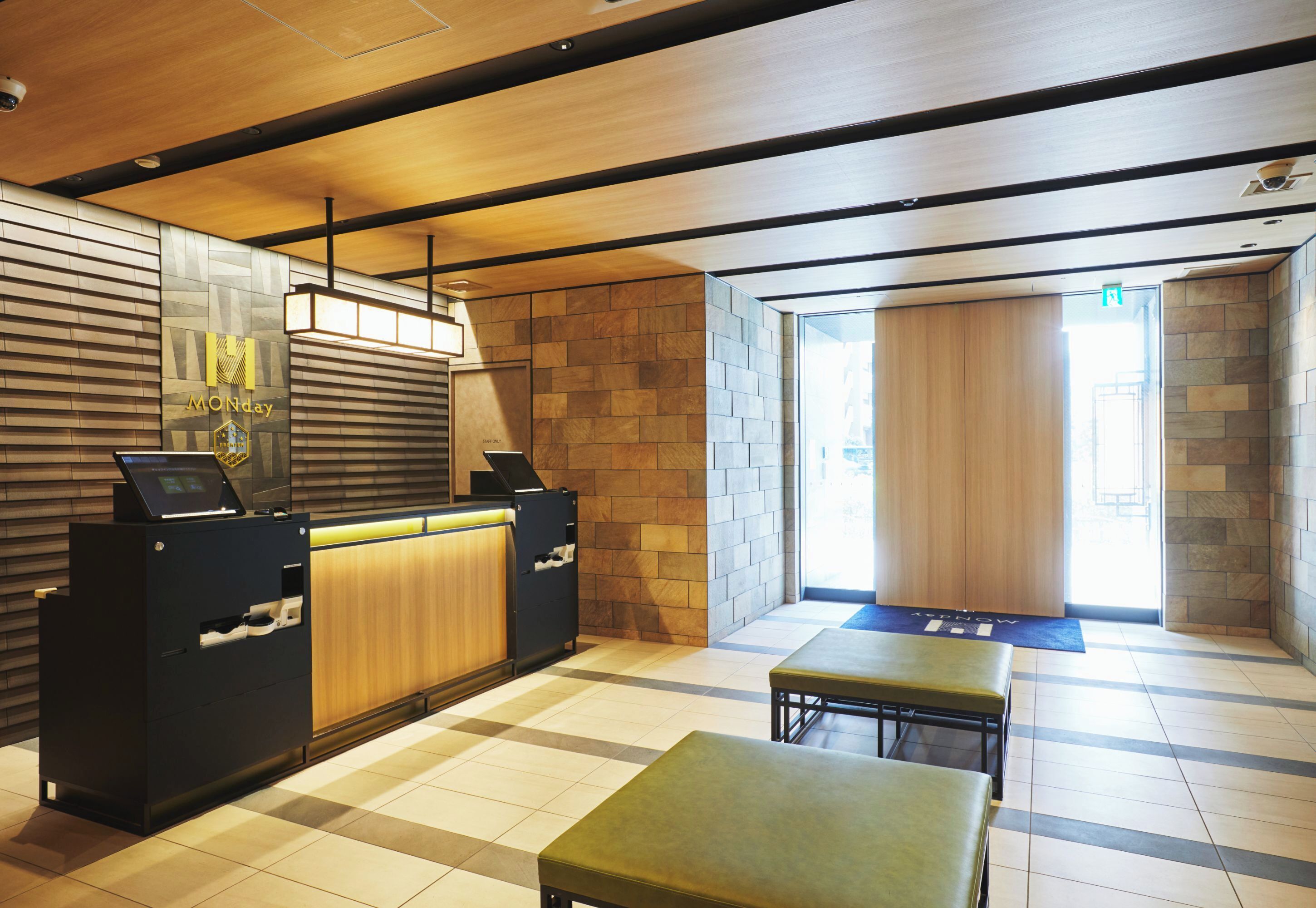 A reception area with a wooden reception desk, a check-in counter, and a seating area with a bench.
