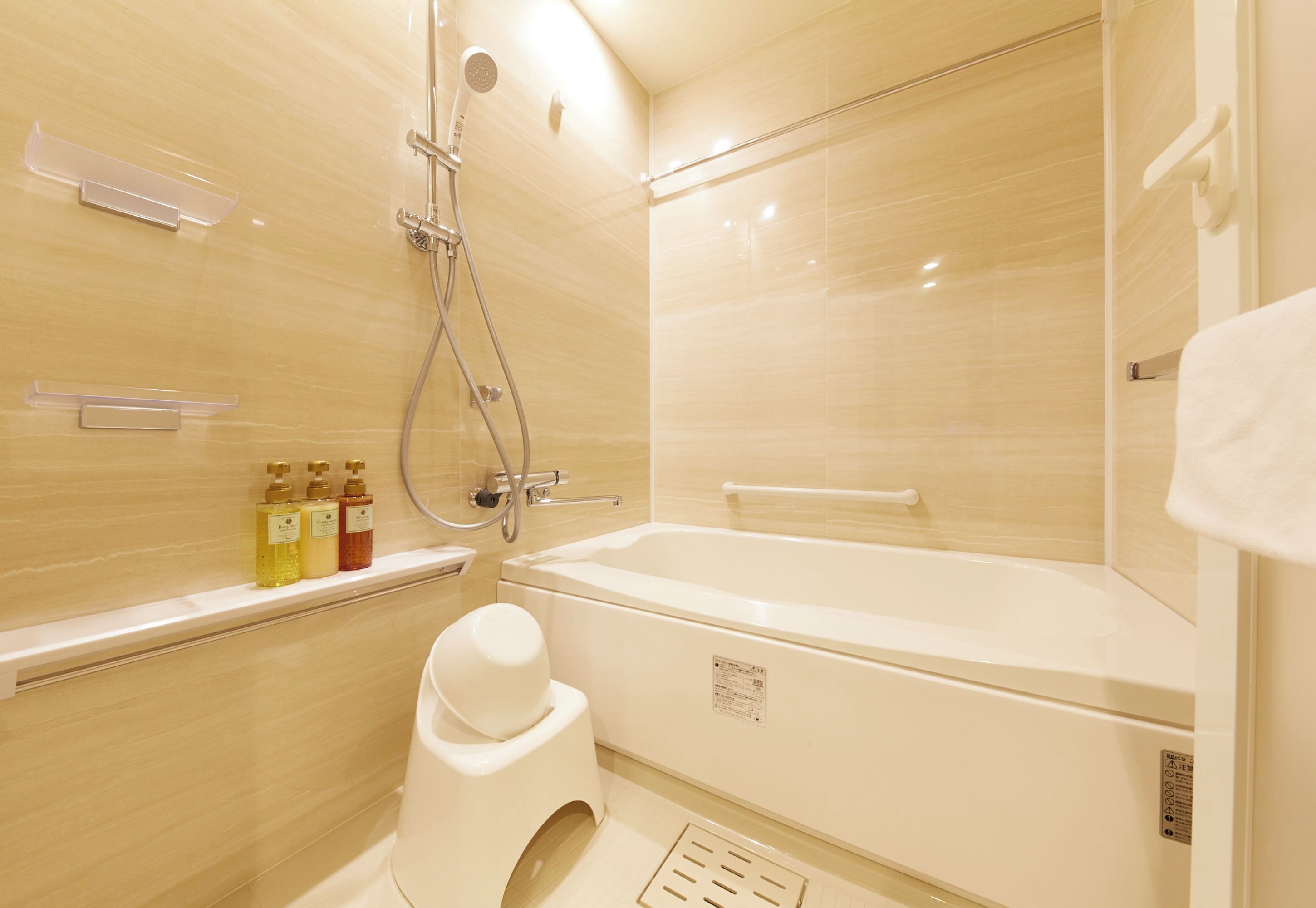A modern bathroom with a bathtub, shower, and toilet.