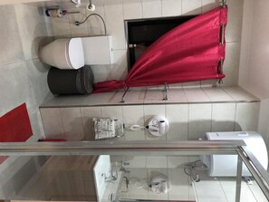 A bathroom with a toilet, bidet, and a shower area.
