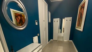 A bathroom with a white vanity, a mirror, and two doors. - Gallipoli Apartment - Activelife (Gallipoli)
