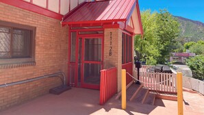 A building with a red facade and a small entrance. - Beautiful Well Preserved Historical 2 bedroom House. 1112B (Glenwood Springs)