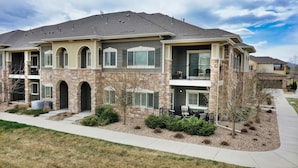A two-story house with a stone facade, multiple windows, and a balcony. - Lavish Tranquil No-Steps Oasis (Westminster)