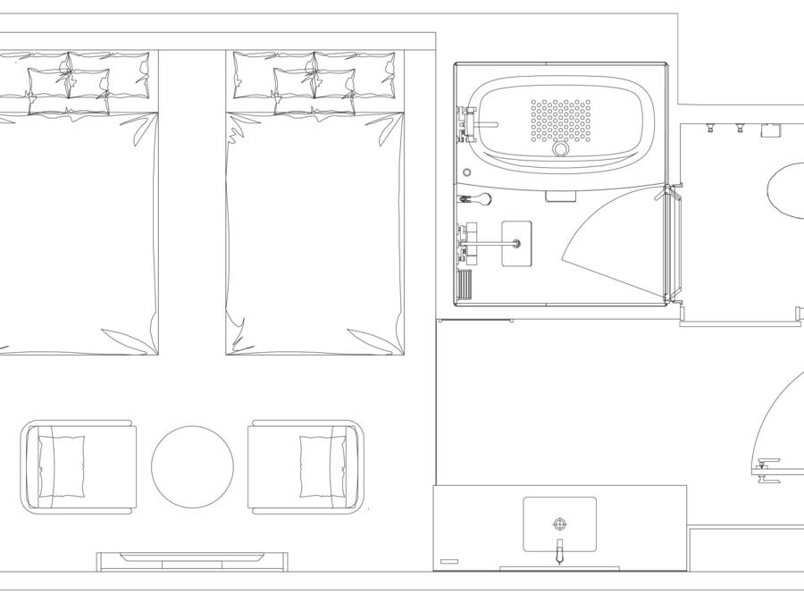 Een plattegrond van een hotelkamer met een bed, een badkamer en een klein zithoekje.