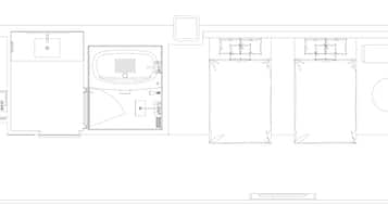 A floor plan of a hotel with a bathroom, a kitchen, and a seating area.