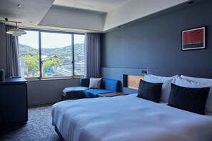 A hotel room with a large bed, a seating area with a table, and a view of a cityscape through large windows. - Nohga Hotel Kiyomizu Kyoto (Kyoto)