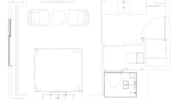 A floor plan of a hotel with a large central room, a separate bathroom, and a small kitchen area.