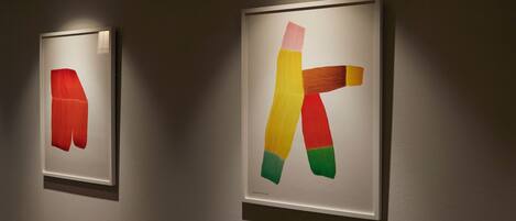 Two framed artworks on a wall.