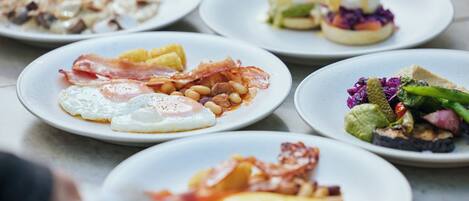 A variety of breakfast dishes on plates.