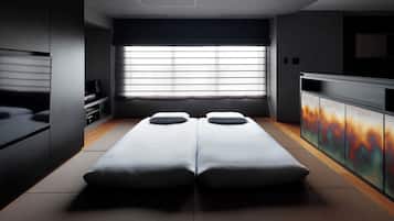 Una habitación moderna con cama, televisor y mueble.