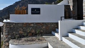 A villa with a stone facade, a sign reading "Villa Vitabel," and a view of a mountain. - Villa Vitabel 3 Bedroom with Infinity Pool and Sea View in Lindos (Lindos)