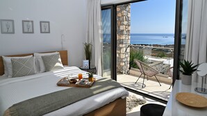 A bedroom with a bed, a breakfast tray, a potted plant, and a view of the sea. - Villa Vitabel 3 Bedroom with Infinity Pool and Sea View in Lindos (Lindos)