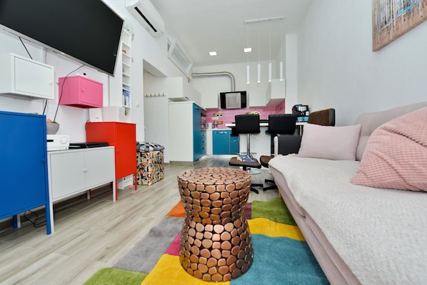 A modern, well-lit room with a sofa, a coffee table, and a TV. - Villa Popandrock Sleeps 5 With Parking (Zadar)