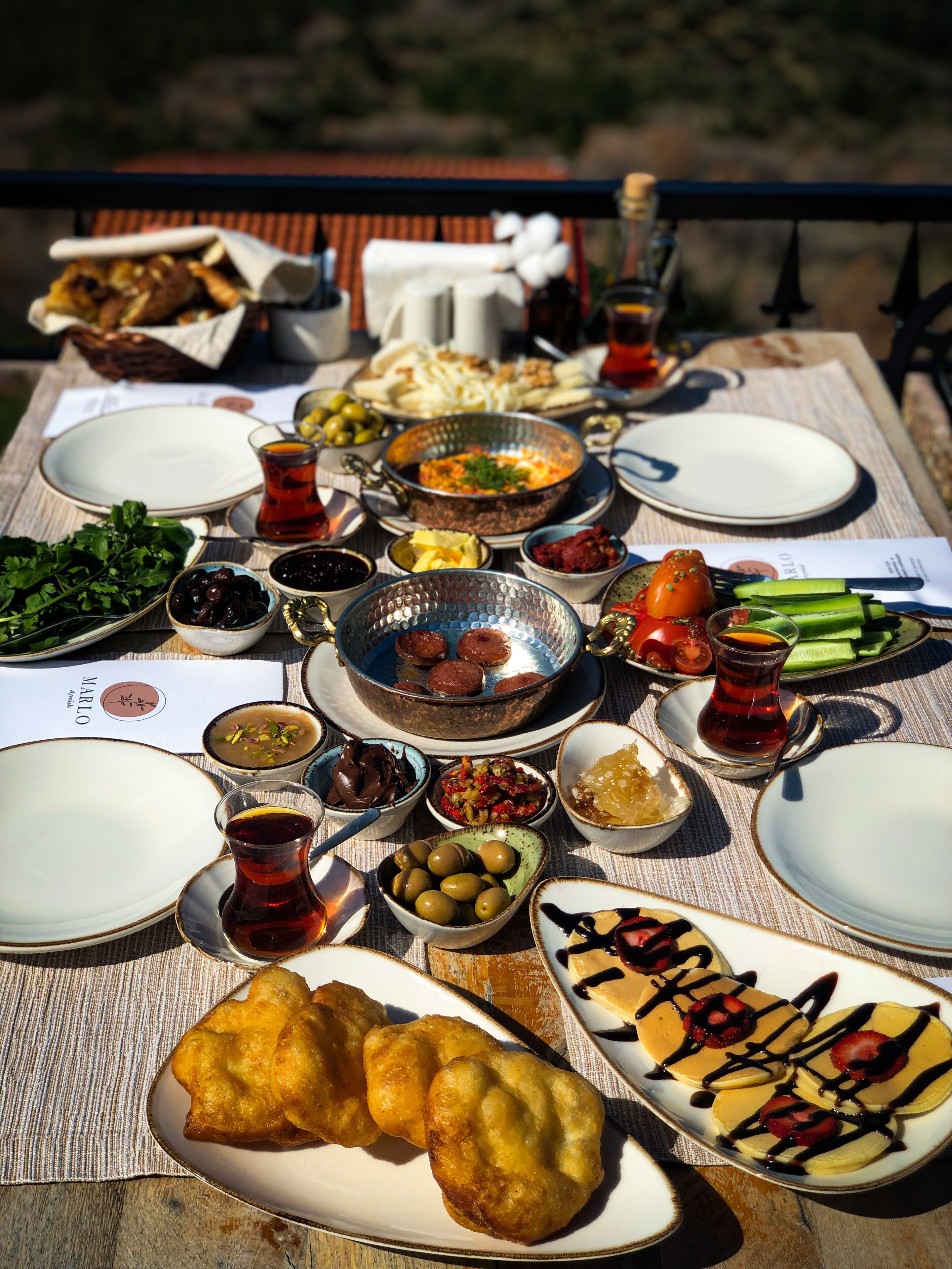 A table set with various dishes and drinks, likely for a meal.