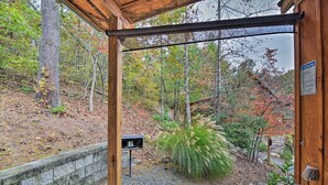 A wooden structure with a view of a forested area. - Chanterelle Cabin w/Hot Tub, Fireplace - Near Asheville! (Weaverville)