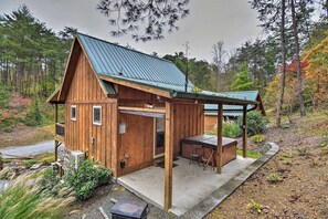 A wooden cabin with a covered patio, a dining area, and a small porch. - Chanterelle Cabin w/Hot Tub, Fireplace - Near Asheville! (Weaverville)