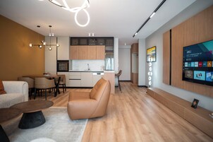 Deluxe Apartment | Living area | 40-inch LCD TV with cable channels, TV