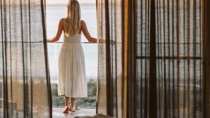 A room with a bed, curtains, and a view through the window. - 'Atra' - Jervis Bay Beach Front Holiday Home (Callala Beach)