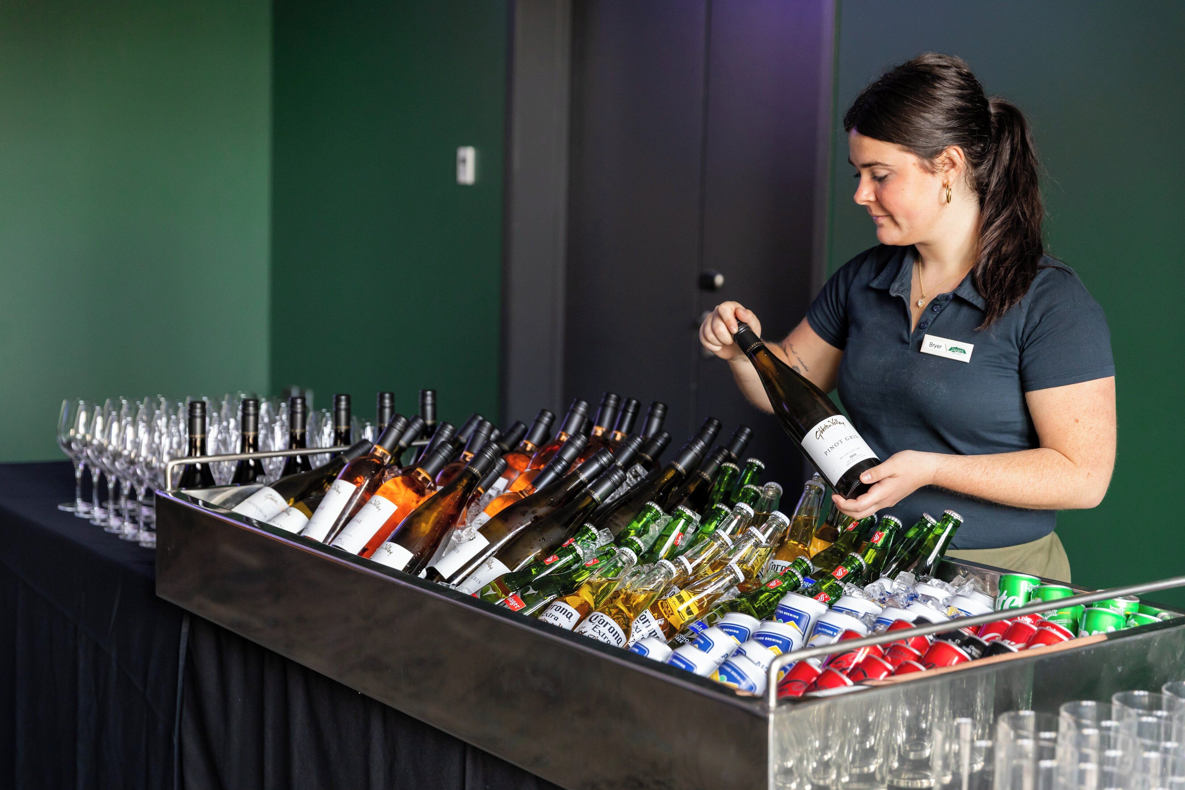 A bar area with a variety of bottles and glasses.