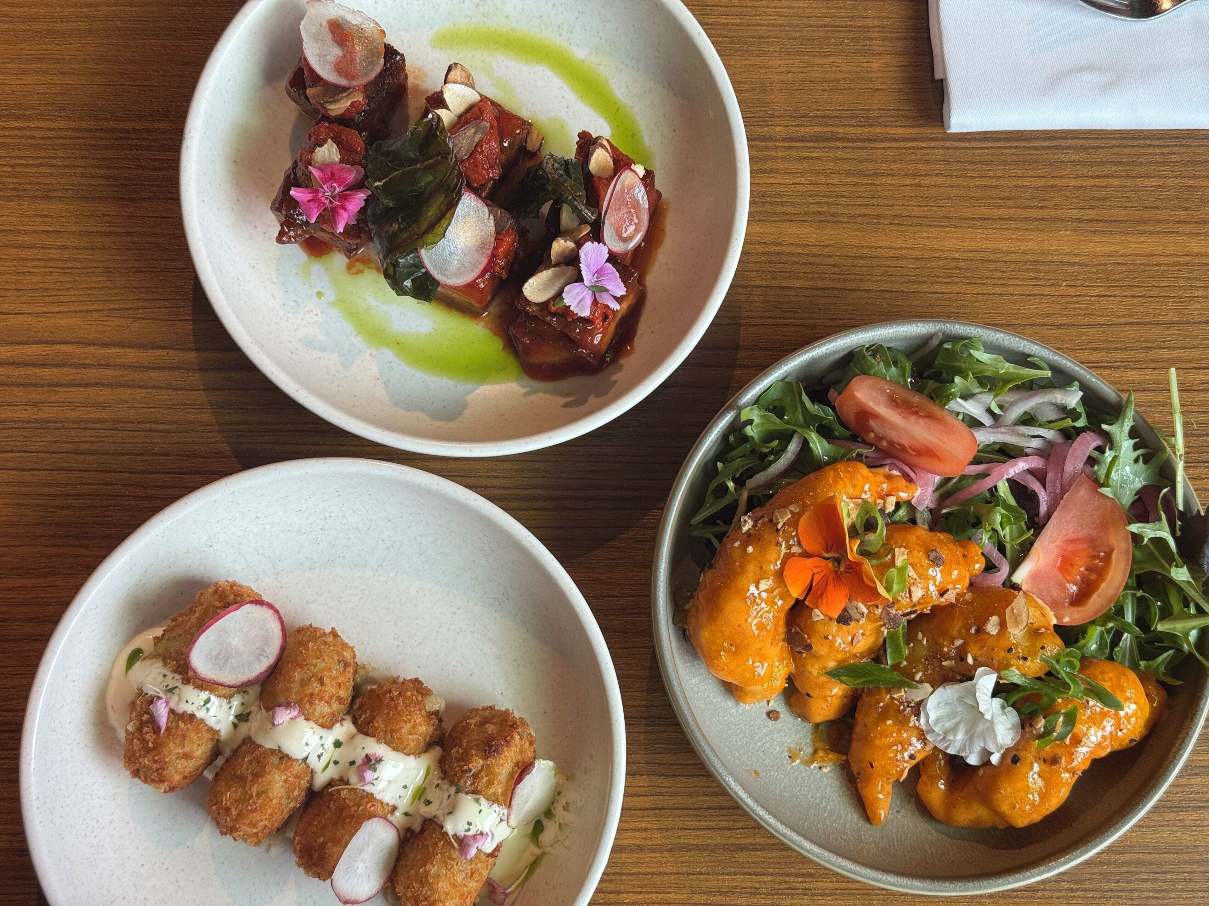 Three dishes on a wooden table.