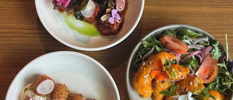Three dishes on a wooden table.