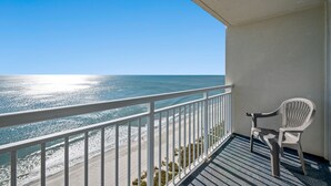 A balcony with a white railing, a white plastic chair, and a view of the ocean. - Bay Watch 1706-1BR/1BA Oceanfront Condo in North Myrtle Beach (North Myrtle Beach)