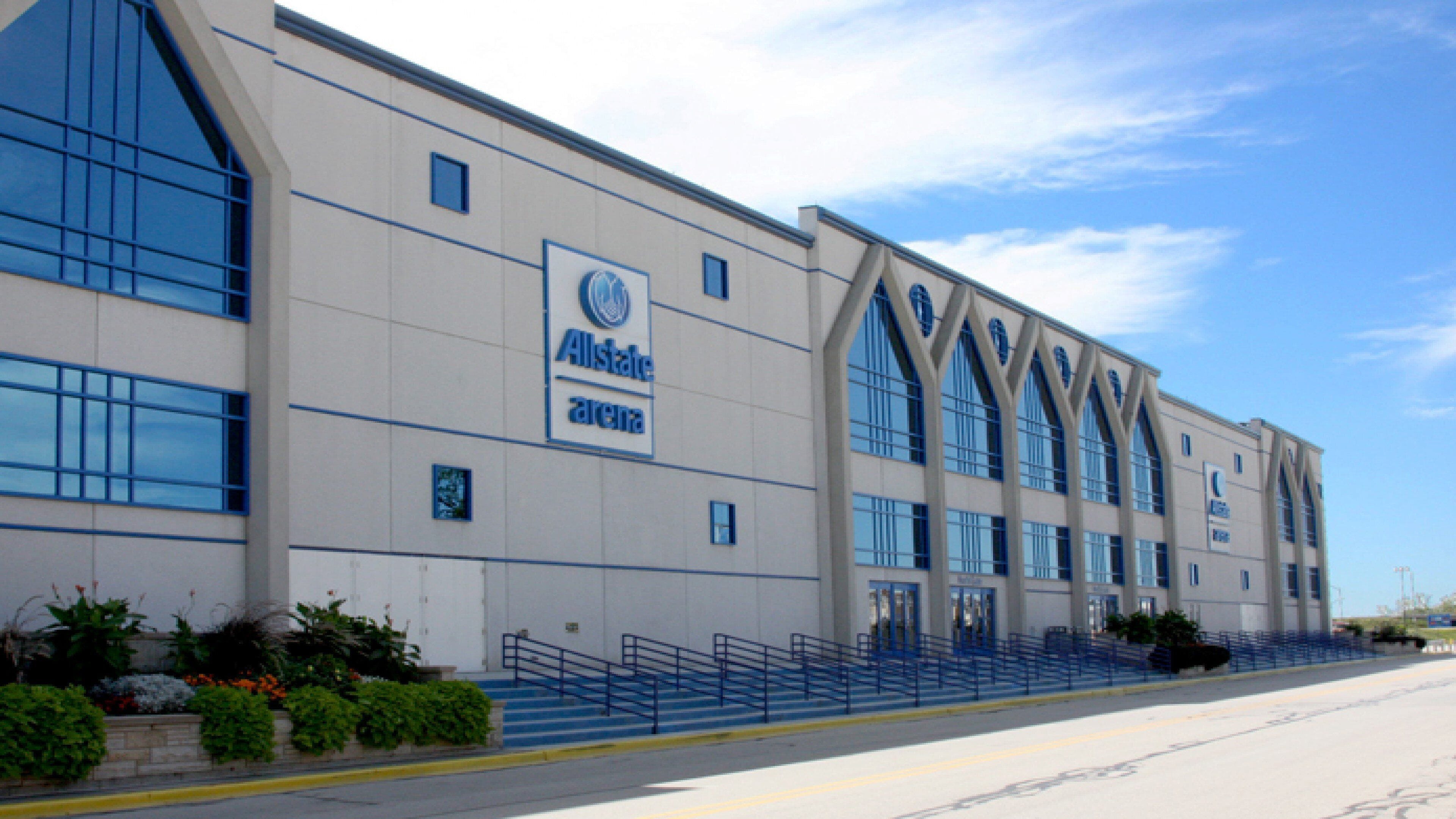 A large, modern building with a prominent Allstate Arena sign, featuring a symmetrical facade with large windows and a central entrance.